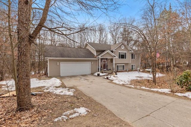 split level home with a garage and concrete driveway