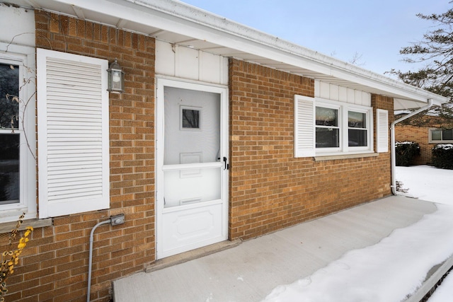 property entrance featuring brick siding