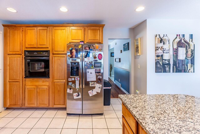 7504 Wiczer Dr, Whitehall, MI 49461 - kitchen with stainless steel fridge with ice dispenser, oven, light stone counters, recessed lighting, and light tile patterned floors