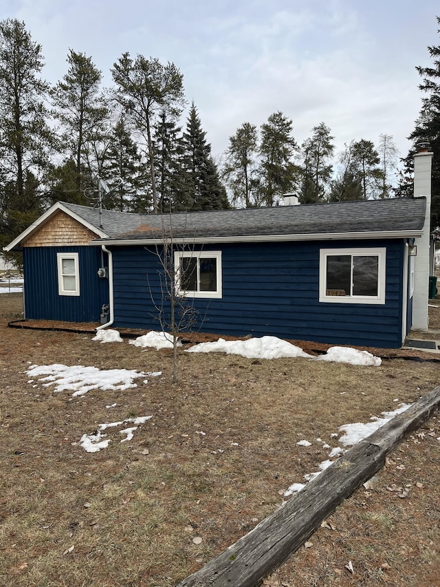 view of front facade featuring a chimney and board and batten siding