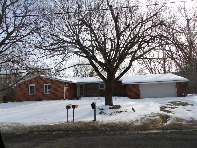 ranch-style home with a detached garage