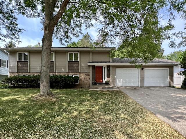 view of front of home featuring a garage, brick siding, driveway, and a front lawn