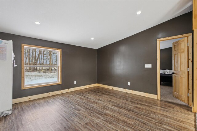 spare room with recessed lighting, dark wood-style flooring, and baseboards