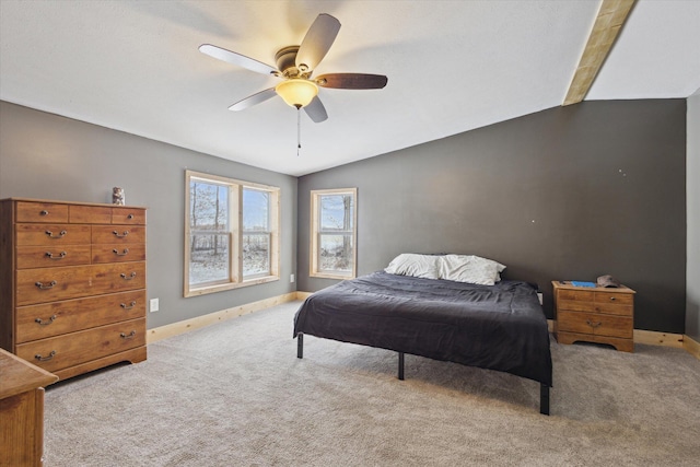 bedroom with light carpet, ceiling fan, lofted ceiling, and baseboards