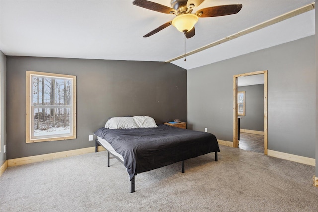 bedroom with vaulted ceiling, multiple windows, and carpet flooring