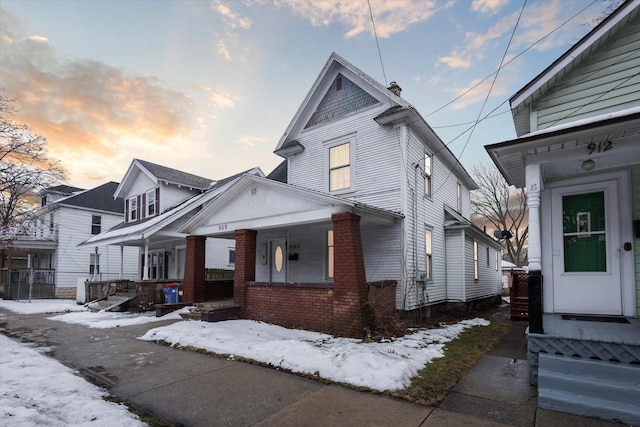 view of front of property featuring a porch and brick siding