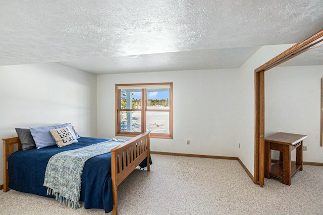 bedroom featuring carpet, a textured ceiling, and baseboards