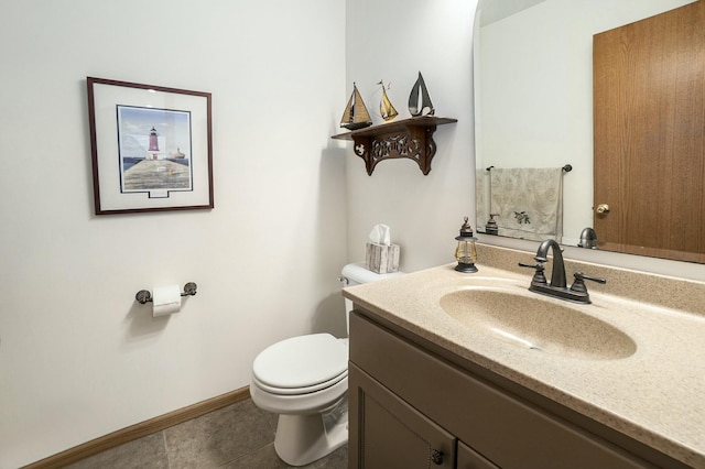 bathroom with baseboards, vanity, toilet, and tile patterned floors