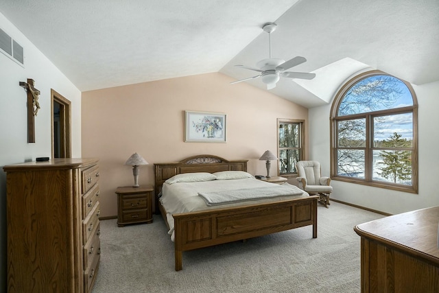 bedroom with light colored carpet, visible vents, vaulted ceiling, ceiling fan, and baseboards