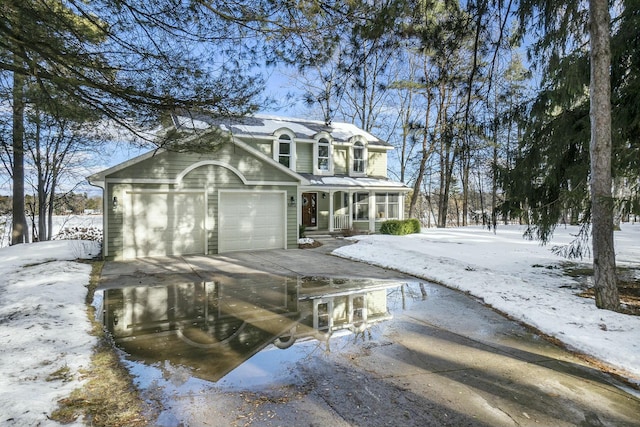 view of front facade with driveway, a porch, and an attached garage