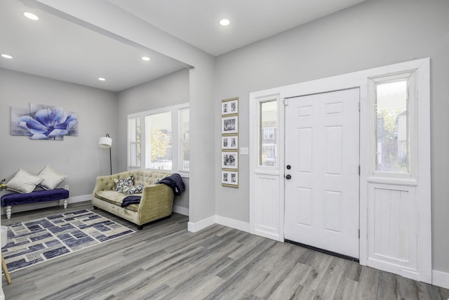 entryway with light wood finished floors, recessed lighting, and baseboards