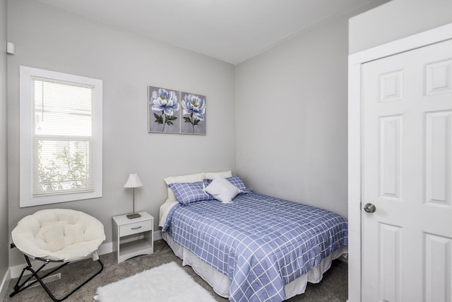 bedroom with carpet and baseboards