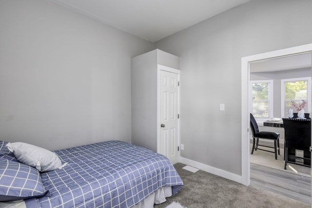 bedroom with baseboards and carpet flooring