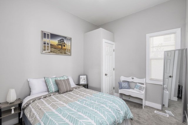 carpeted bedroom with visible vents and baseboards