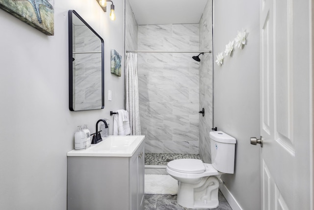 bathroom with toilet, a shower stall, baseboards, and vanity