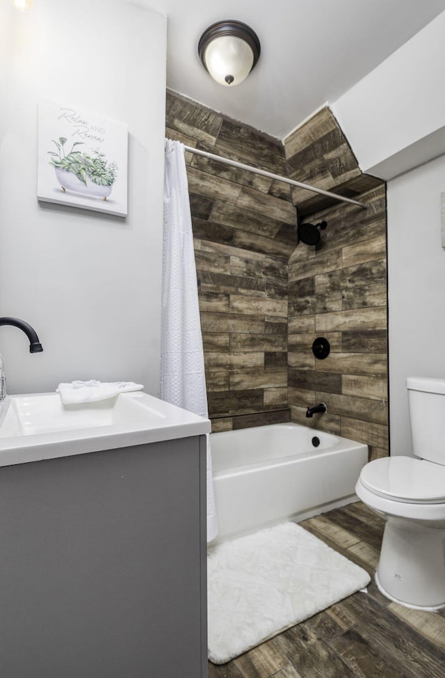 bathroom featuring vanity, shower / bath combo, wood finished floors, and toilet