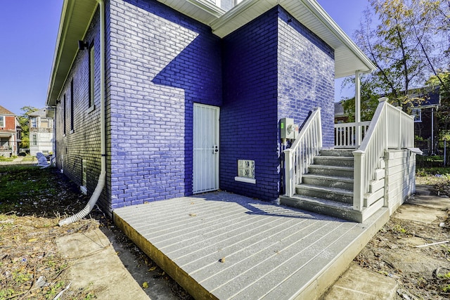 exterior space featuring brick siding and a deck