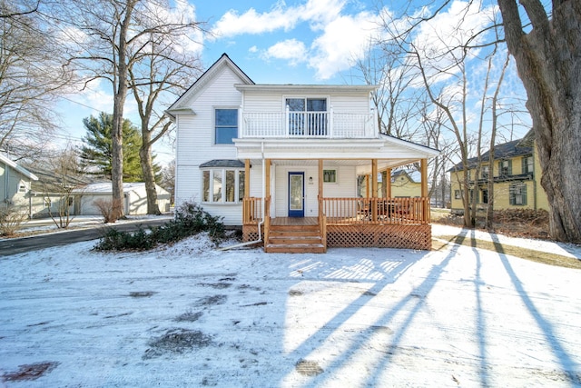 view of front of property featuring a balcony and a porch