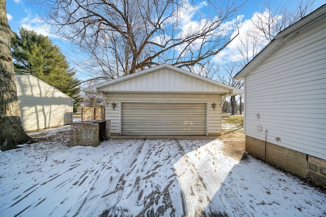 snow covered garage with a garage