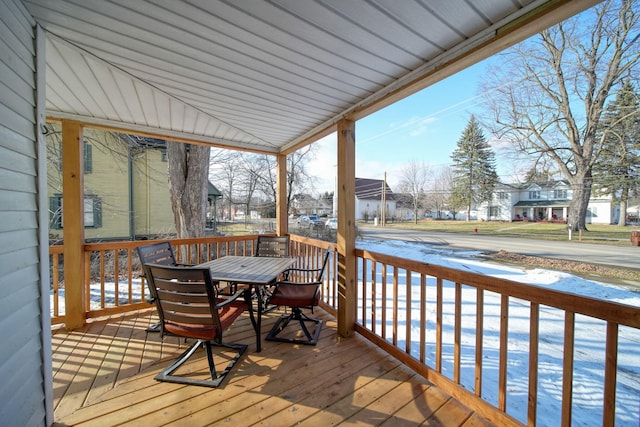 wooden deck featuring a residential view and outdoor dining space