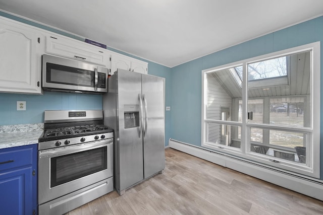 kitchen with a baseboard heating unit, white cabinetry, appliances with stainless steel finishes, and light countertops