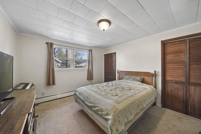 bedroom with carpet floors, a closet, ornamental molding, and baseboard heating