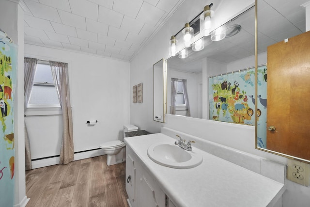 bathroom with toilet, wood finished floors, vanity, baseboard heating, and crown molding