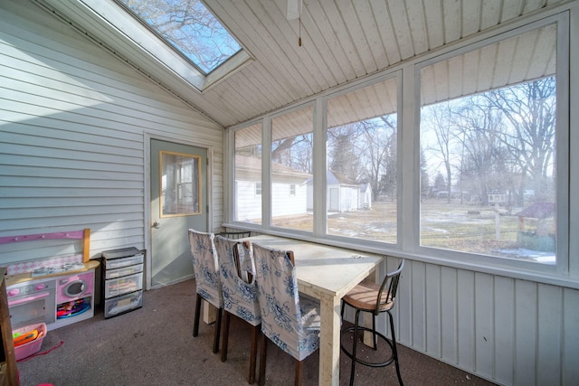 sunroom with vaulted ceiling with skylight