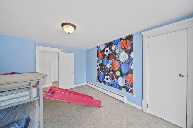 bedroom with carpet floors, baseboards, and baseboard heating