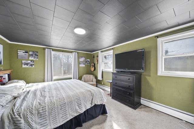 carpeted bedroom featuring baseboards, a baseboard heating unit, baseboard heating, and crown molding