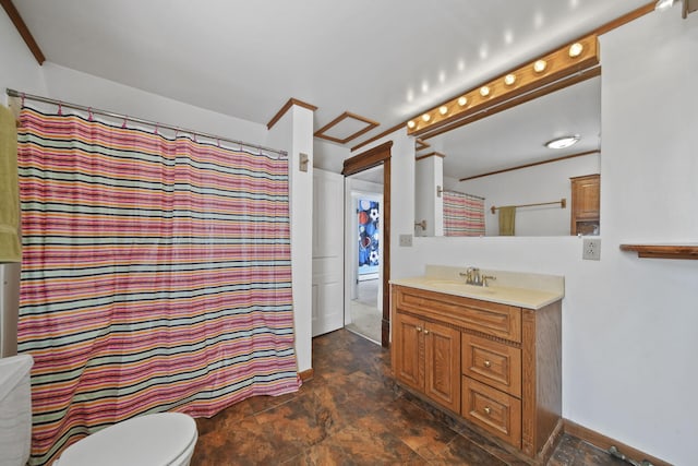 bathroom featuring toilet, stone finish flooring, crown molding, and vanity