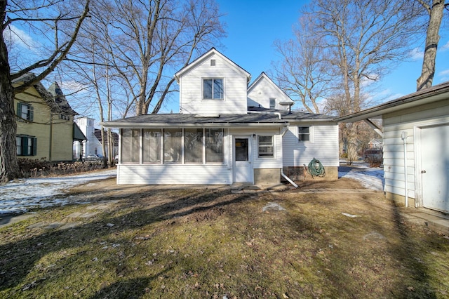 view of front of property featuring a front lawn and a sunroom