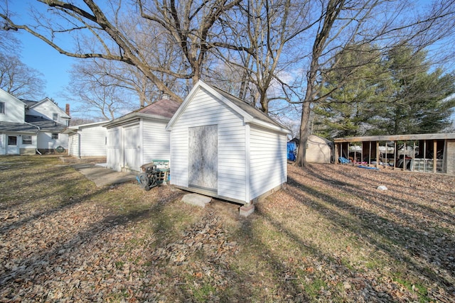 view of property exterior featuring a storage shed, a yard, and an outdoor structure