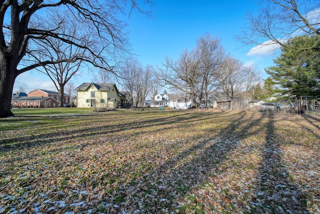 view of yard featuring a residential view and fence