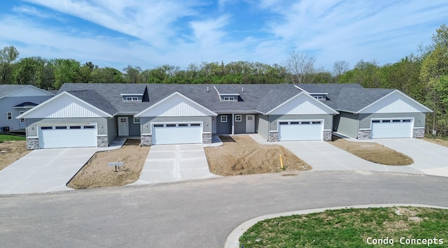 6625 Shoreside Ct SE, Grand Rapids, MI 49548 - view of front of home with stone siding, board and batten siding, and roof with shingles