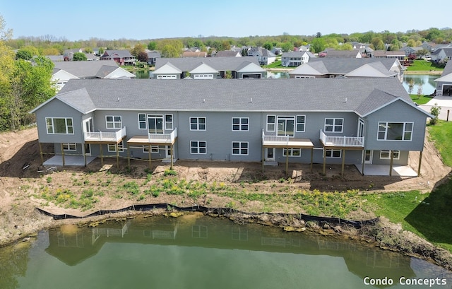 6625 Shoreside Ct SE, Grand Rapids, MI 49548 - rear view of house with a residential view, a deck with water view, and a shingled roof