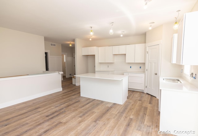 6625 Shoreside Ct SE, Grand Rapids, MI 49548 - kitchen featuring a center island, white cabinetry, and light wood-type flooring