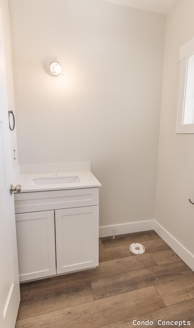 6625 Shoreside Ct SE, Grand Rapids, MI 49548 - bathroom with wood finished floors, vanity, and baseboards