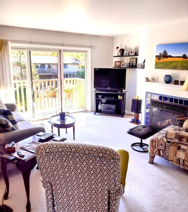 living room with carpet floors and a glass covered fireplace