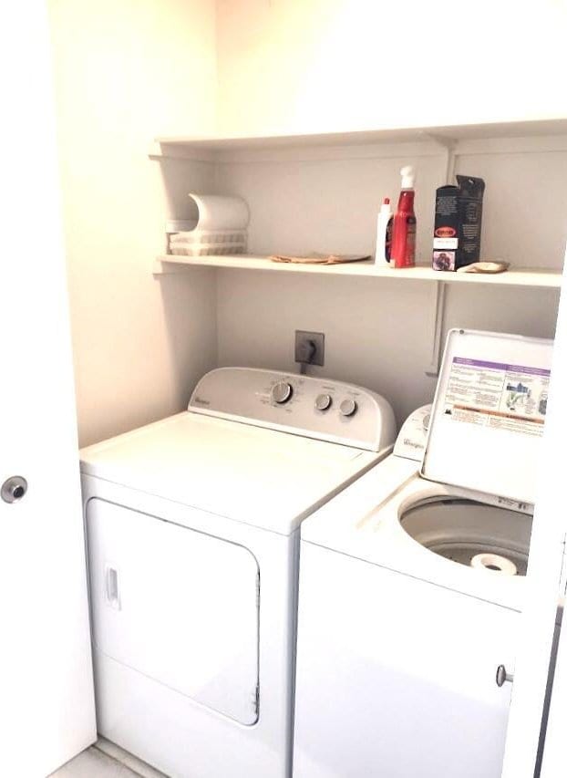 washroom featuring washing machine and dryer and laundry area