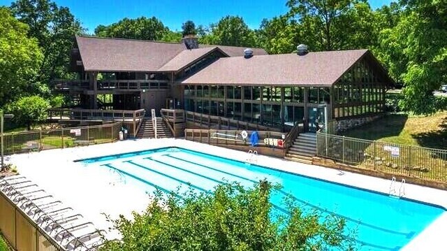 community pool featuring stairs and fence