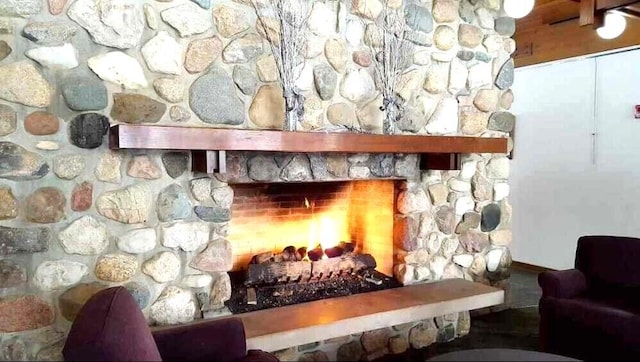 room details featuring a warm lit fireplace