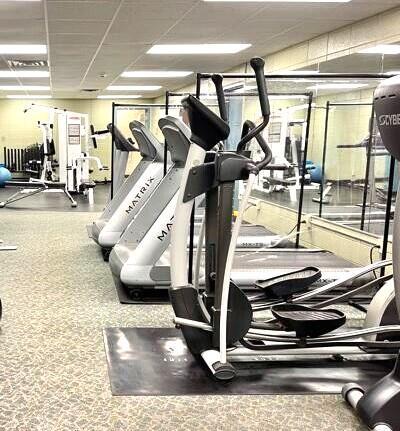 exercise room with a paneled ceiling