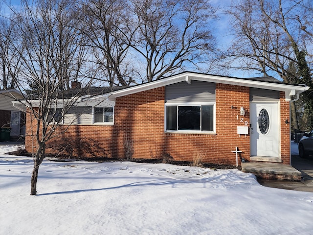 view of front of house with brick siding and a chimney