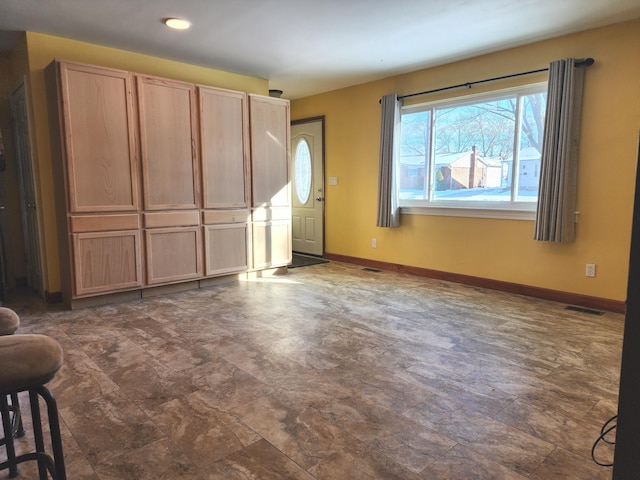 interior space featuring baseboards and visible vents