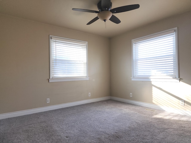 spare room featuring carpet, a ceiling fan, and baseboards