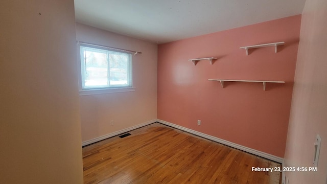 unfurnished room featuring light wood-style floors and visible vents