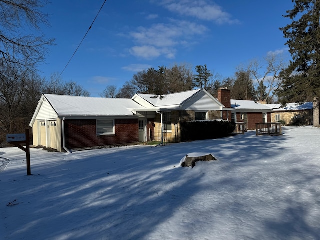 single story home featuring brick siding and a chimney