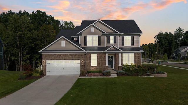 view of front of house featuring a garage, a front yard, brick siding, and driveway