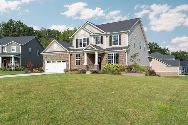 craftsman-style home with driveway, a garage, a front lawn, and brick siding